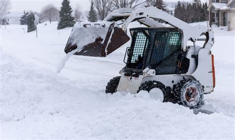 using a skid steer for snow removal|skid steer plowing snow.